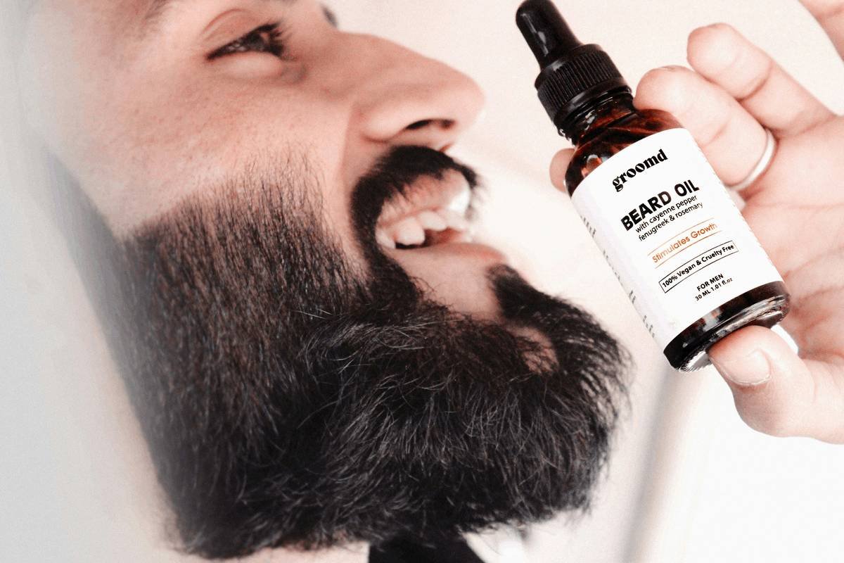 Infographic showing causes of beard dryness: harsh soaps, cold weather, lack of humectants, and alcohol-based products